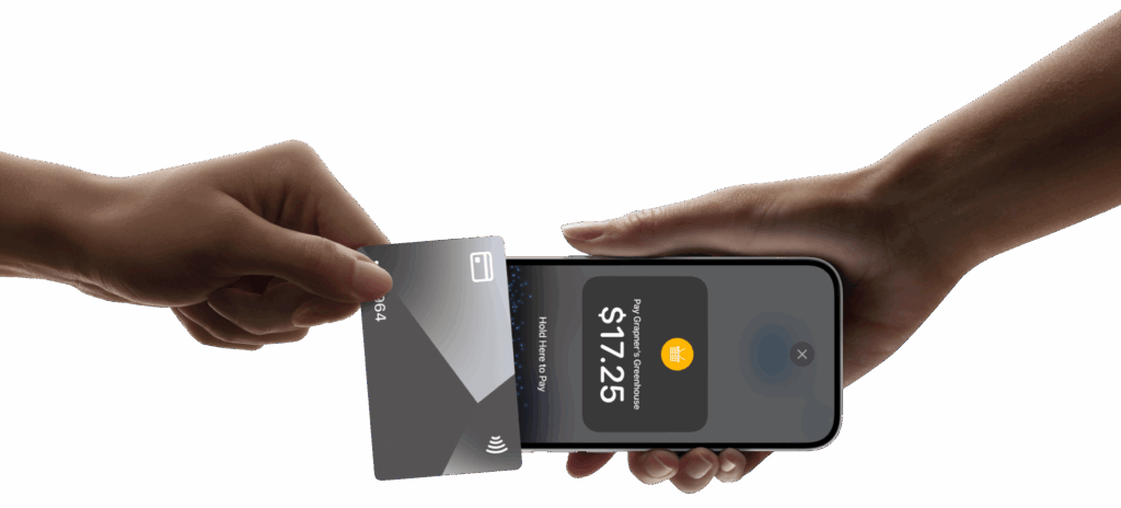 two hands doing a checkout process. one hand holdning credit card and another one holdning a phone.